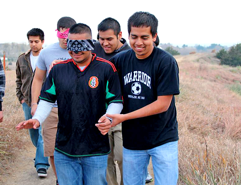 Jaime Lopes of Gibbon, left, is blindfolded and led on The Trail of Tears Walk by Daniel Alarcon of Schuyler. The event was part of Native American Heritage Month activities hosted this month by the Student Kouncil of Intertribal Nations organization at UNK. (Photo by Adrianna Tarin/UNK News)