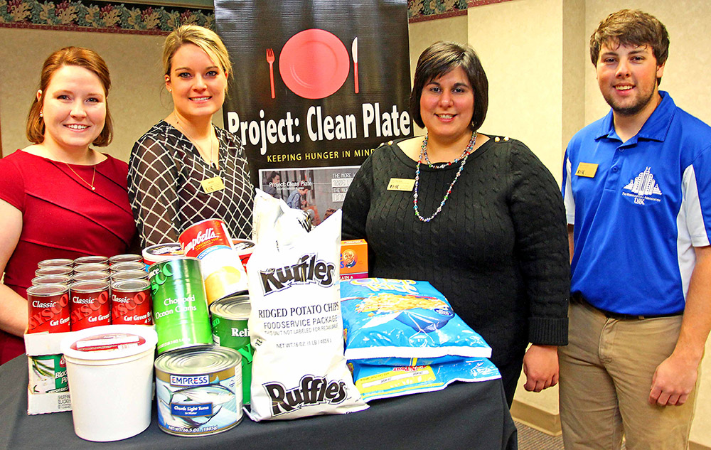 The Salvation Army Board President Andrea McClintic, left, is presented food as part of the University of Nebraska at Kearney’s Project: Clean Plate program from, left to right, Mardi Engels of UNK Dining Services, Residence Hall Complex Director Jen Kacere and student representative Ross Nicklos. (Photo by Todd Gottula/UNK Communications)