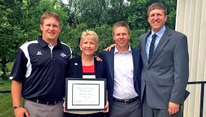 Barb Estes was given the the University of Nebraska Board of Regents KUDOS award on July 18. Attending the presentation were her sons (left to right) Luke, Erik and Aaron.