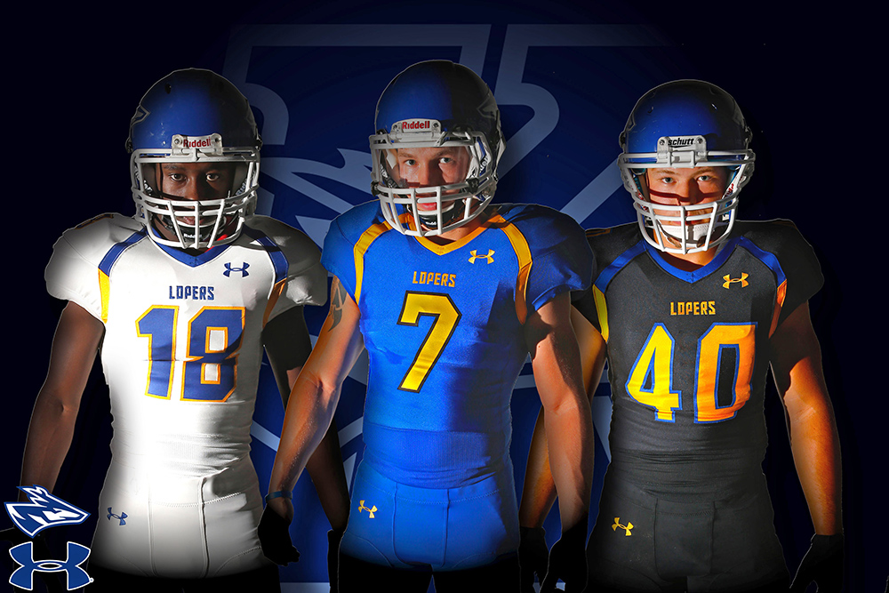 UNK football players, from left to right, in the team’s new Under Armour uniforms include: receiver Tityus Mitchell, quarterback Bronson Marsh and linebacker Tyke Kozeal. UNK’s home jersey is blue, the away jersey is white, and a third alternate jersey is black. (Photo by Corbey R. Dorsey, UNK Communications)