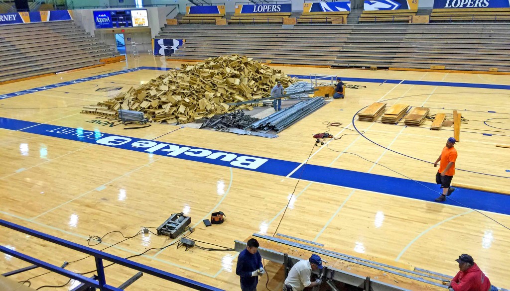 Workers remove the old bench-style seating at UNK’s Health and Sports Center to make way for new chair back seating that is being installed. The $700,000 project will be finished in mid-August.