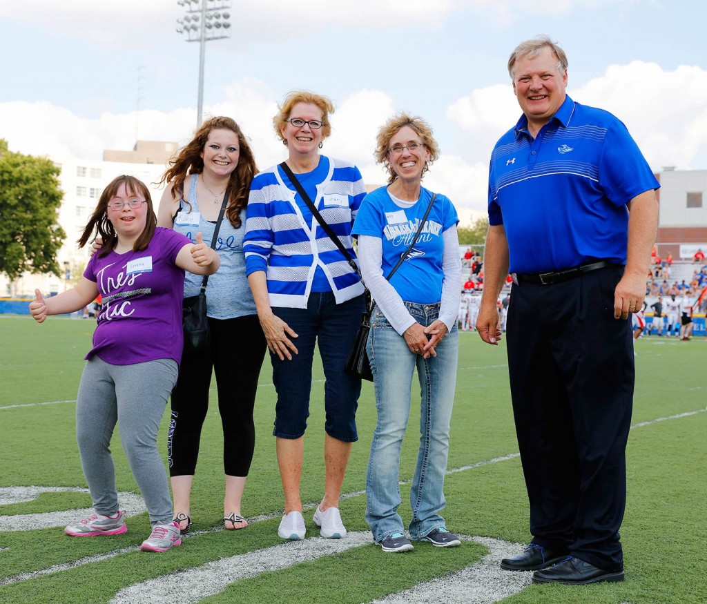 The Kovanda family of Grand Island is UNK’s Outstanding Family Award winner for 2015. Katie Kovanda, second from left, and her mother Mary, third from left, were honored by UNK Chancellor Doug Kristensen at Saturday’s Loper football game. Also pictured are the Kovanda’s friends Nancy Chavez of Grand Island and her daughter, Serena, far left.