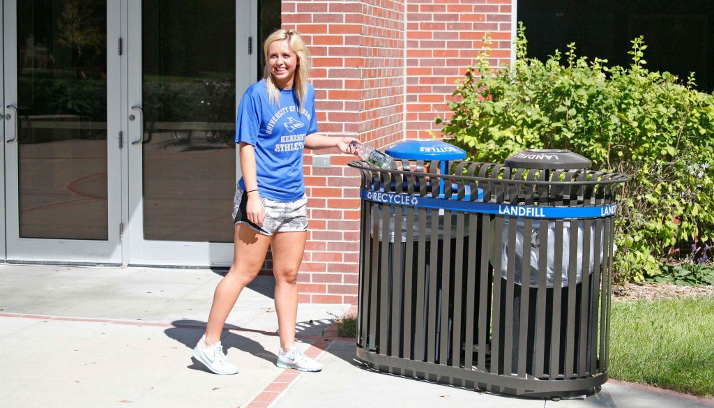 UNK student Brandy Herley of Spalding uses one of the 52 new outdoor recycling containers on campus.
