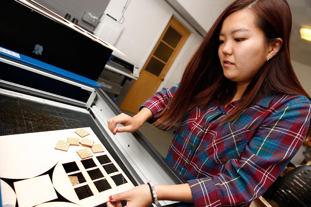 Satsuki Morimoto, a freshman interior design student from Japan, uses the laser cutter in the new fabrication lab in the interior design department at the University of Nebraska at Kearney.