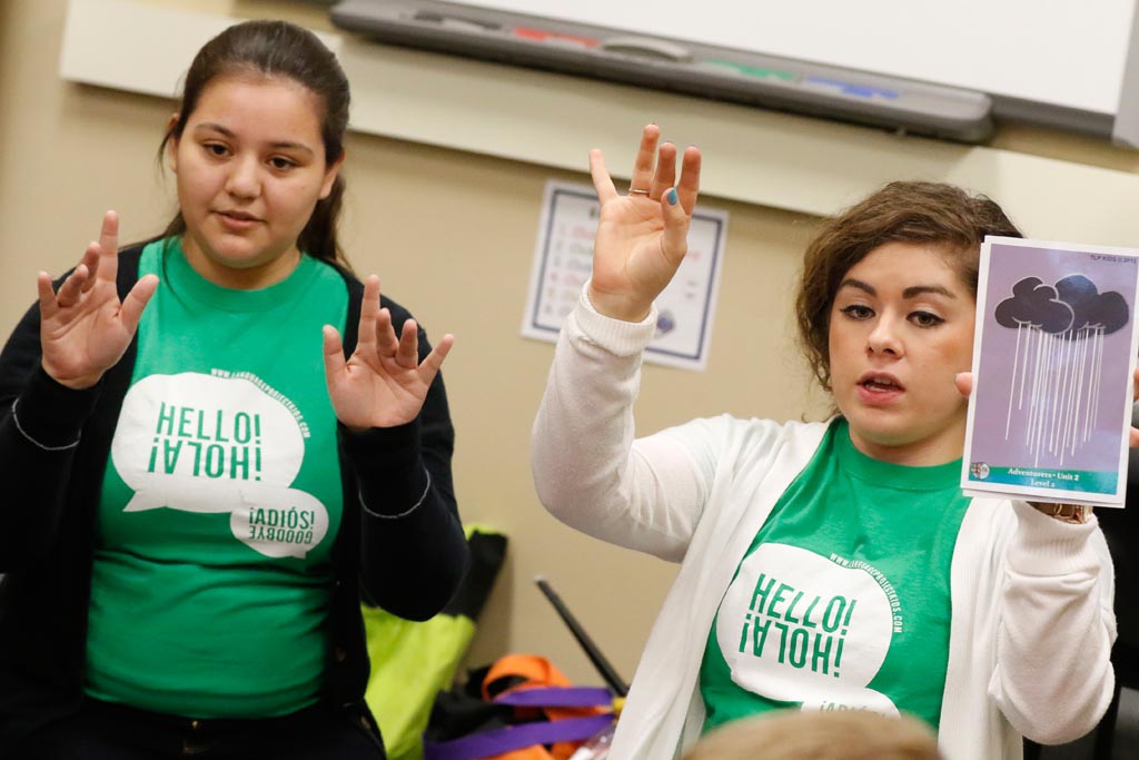 UNK students Briana Orellana of Cozad, right, and Yohana Lopez of Lexington interact with students at Kearney’s Central Elementary through The Language Project. The program is designed to integrate Spanish language teaching in elementary schools.