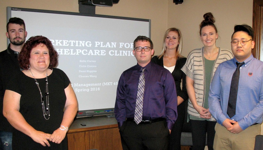 HelpCare’s Garrett Vetter and Cheryl Bressington, far left, worked with UNK students, left to right, Colin Cimino of Kearney, Demi Higgins of Bennington, Kelle Carver of Shawnee, Kan., and Chenxu Wang of China in developing a marketing plan for the free clinic.