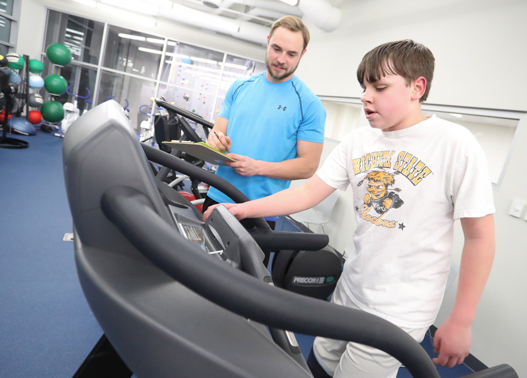 Boy Scout Kyson Krepel, right, undergoes fitness testing with guidance from UNK student Andrew Jacobsen. Krepel is among 23 scouts developing fitness plans and working toward merit badges under the guidance of UNK students. (Photo by Corbey R. Dorsey/UNK Communications)