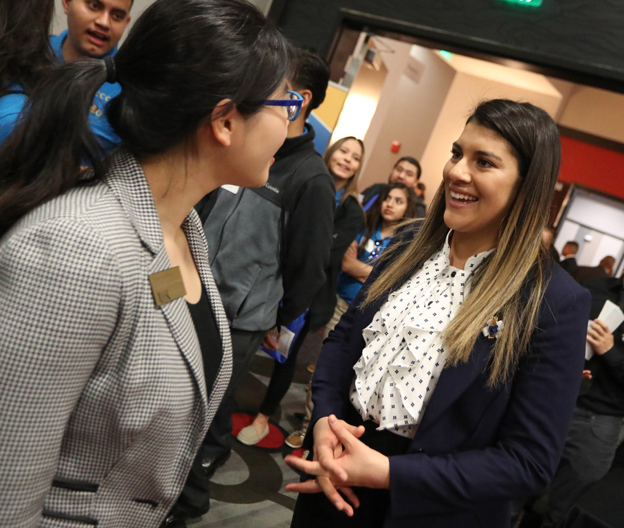 UNK freshman Jennifer Garcia of Shelton, right, speaks with Thompson Scholars Learning Community Assistant Director Chuanyao Zheng, left, at Friday’s Nebraska Cultural Unity Conference in Kearney. More than 300 attended the event, which promotes higher education for diverse, multicultural students. (Photo by Corbey R. Dorsey/UNK Communications)