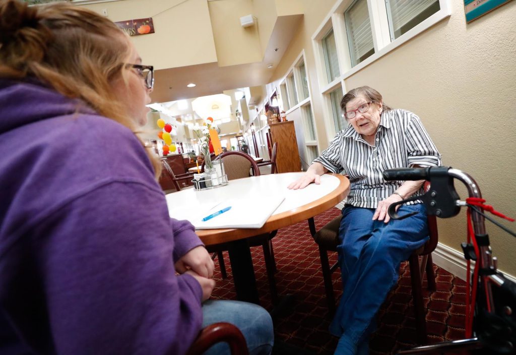 Sidney Graham of Shelton, left, conducts an interview with Delores Harm at the Cambridge Court senior living facility in Kearney. (Photo by Corbey R. Dorsey, UNK Communications)