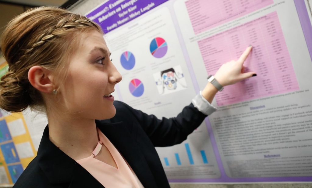 Sophomore Taylor Kizer discusses the links between social media use and health issues such as depression and anxiety during Wednesday’s Student Research Day at the University of Nebraska at Kearney. (Photo by Corbey R. Dorsey, UNK Communications)