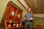 Will Stoutamire, director of the G.W. Frank Museum of History and Culture on the UNK campus, shows off a collection of decorative arts added as a permanent exhibit on the museum’s second floor. (Photo by Corbey R. Dorsey, UNK Communications)