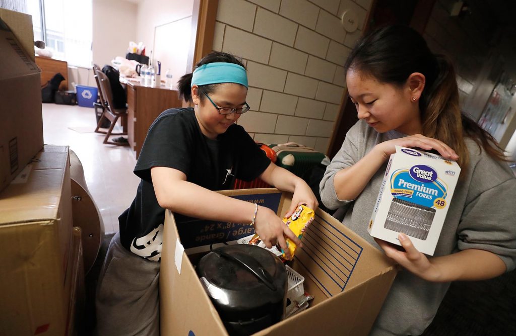 UNK students Suzuha Sasaki, left, and Mizuki Yoshino pack up their belongings Wednesday afternoon inside Randall Hall. It was a busy week across campus as students living in residence halls moved out for the summer. (Photo by Corbey R. Dorsey, UNK Communications)