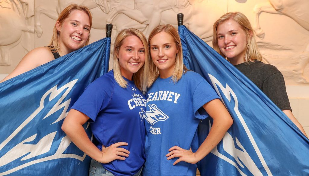 The Petersen sisters are familiar faces around the UNK campus. Sarah and Emily, front row, from left, are members of the UNK Cheer Squad and Rebekah and Hannah, back row, from left, are part of the UNK Pride of the Plains Marching Band Color Guard. (Photo by Corbey R. Dorsey, UNK Communications)