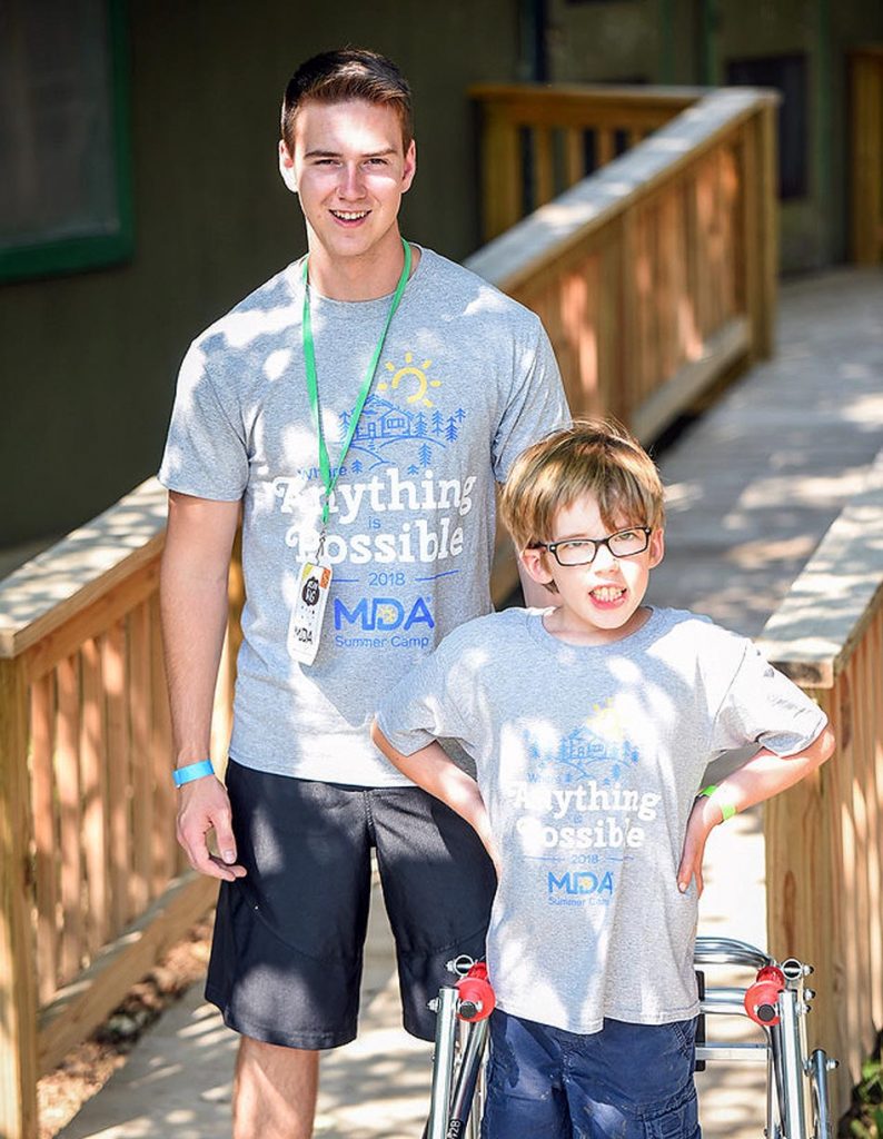 Corey Johnson, left, witnessed muscular dystrophy’s impact last summer while serving as a counselor during a weeklong camp organized by the Muscular Dystrophy Association of Nebraska. (Courtesy photo, MDA of Nebraska)