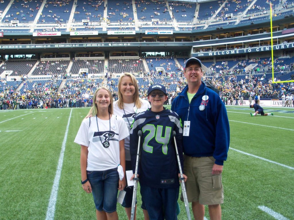 From left, Katie, Deb, Kyle and Kip Anderson pose for a photo while attending a Seattle Seahawks game in September 2012. The Make-A-Wish Foundation arranged the trip for Kyle and his family since the Seahawks are his favorite NFL team. (Photo courtesy of the Seattle Seahawks)