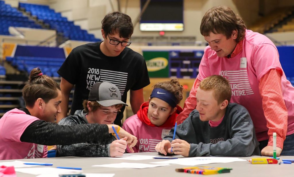 UNK student Dakota Brodigan of Wood River, back row left, works with area high schoolers Thursday during New Venture Adventure at UNK. “I’ve always thought about having my own business, but I never really knew where to start,” said team member Richard Hecht, front row left, a junior at Lexington High School. “This is a good way to get an idea of what you have to do.” (Photo by Corbey R. Dorsey, UNK Communications)