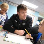 UNK head wrestling coach Dalton Jensen chats with students at Meadowlark Elementary School during a recent visit. The UNK wrestling team is partnering with the Kearney elementary school through the new Loper AthLEADS program. (Photo by Corbey R. Dorsey, UNK Communications)