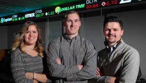 UNK business students use concepts they’re learning in the classroom to make real investments through the William Bauhard Student Managed Investment Fund. From left, seniors Madisson Whalen, Adam Starr and Tristan Crook, who recently placed second in a collegiate stock pitch competition in Chicago, say this experience helps prepare them for their future careers. (Photo by Corbey R. Dorsey, UNK Communications)