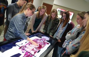 Ellie Miller, a radiography instructor with the University of Nebraska Medical Center College of Allied Health Professions, shows high schoolers the Anatomage Table inside the Health Science Education Complex during last week’s Health Careers Club session at UNK. (Photo by Corbey R. Dorsey, UNK Communications)