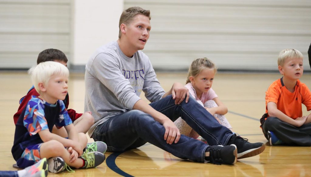 UNK senior Brendan Blackburn leads home-schooled children during an activity in Cushing Coliseum. About 100 home-schooled kids come to campus each Friday for a physical education program that gives UNK students hands-on experience ahead of their teaching careers. (Photo by Corbey R. Dorsey, UNK Communications)