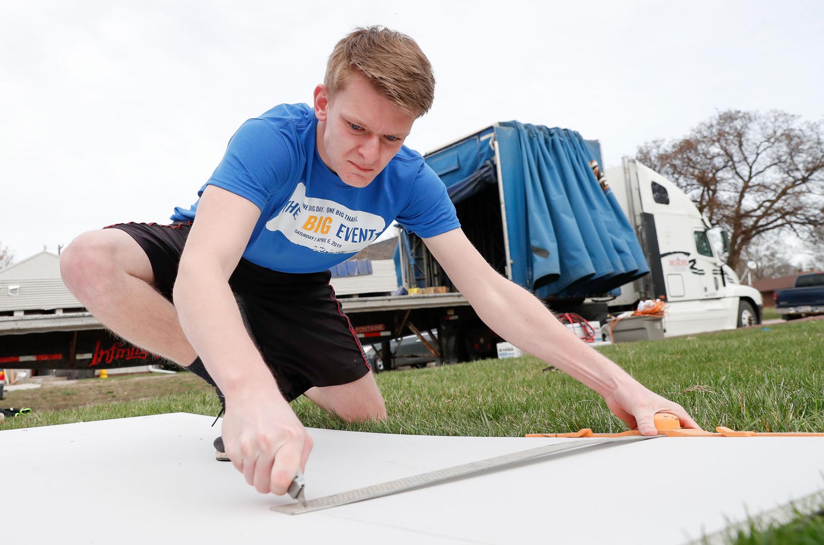 Connor Rockwell of Norfolk cuts Sheetrock Saturday while helping with flood recovery efforts in Gibbon. Rockwell was among 500 University of Nebraska at Kearney students volunteering in Kearney and area communities as part of UNK’s The Big Event. (Photo by Corbey R. Dorsey, UNK Communications)