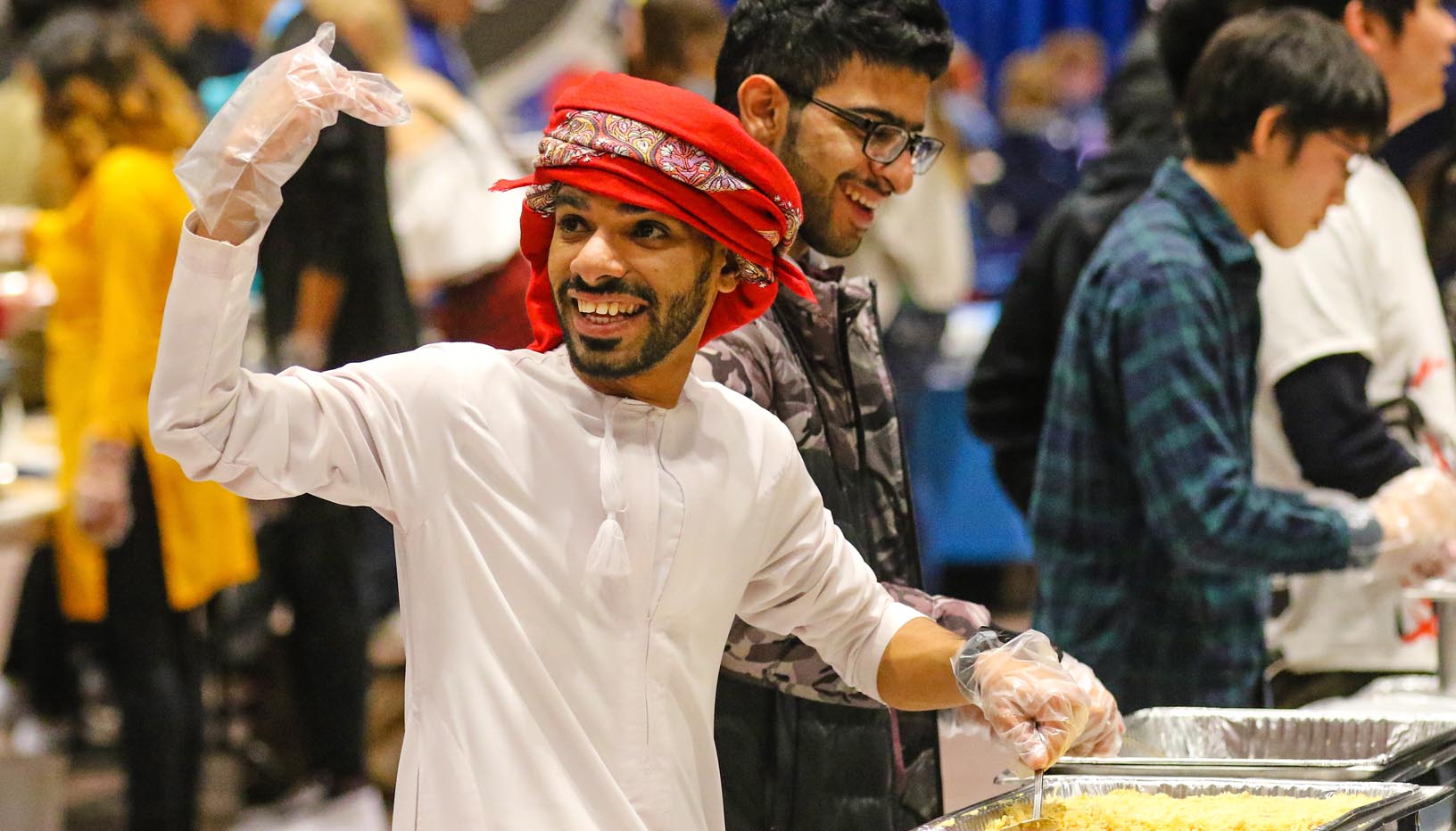 Khalid Alrasbi of Oman serves food at UNK's International Food and Cultural Festival. (Photo by Todd Gottula, UNK Communications)