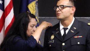 Armando Chavez has his new rank pinned by his mother, Rosa Torres, during an ROTC commissioning ceremony Friday at UNK. Chavez, who graduated Friday with a Bachelor of Arts in Education, will serve as a second lieutenant in the Nebraska Army National Guard’s 67th Maneuver Enhancement Brigade in Lincoln. (Photo by Tyler Ellyson, UNK Communications)