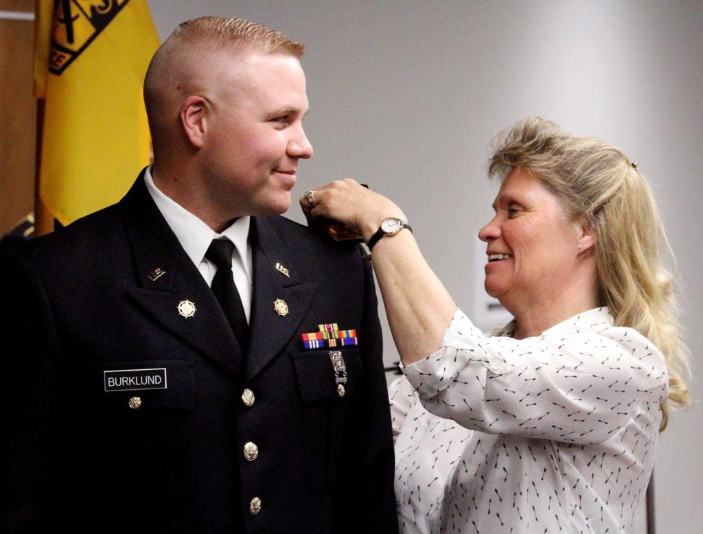 James Burklund has his new rank pinned by his mother, Cheri Mehuron, during an ROTC commissioning ceremony Friday at UNK. Burklund, who is currently pursuing a master’s degree through UNK, is a second lieutenant with the Nebraska Army National Guard’s 1075th Transportation Company in McCook. (Photo by Tyler Ellyson, UNK Communications)