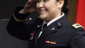 Jeysel Olmos gives her first salute as a second lieutenant in the Nebraska Army National Guard during an ROTC commissioning ceremony Friday at UNK. (Photo by Tyler Ellyson, UNK Communications)