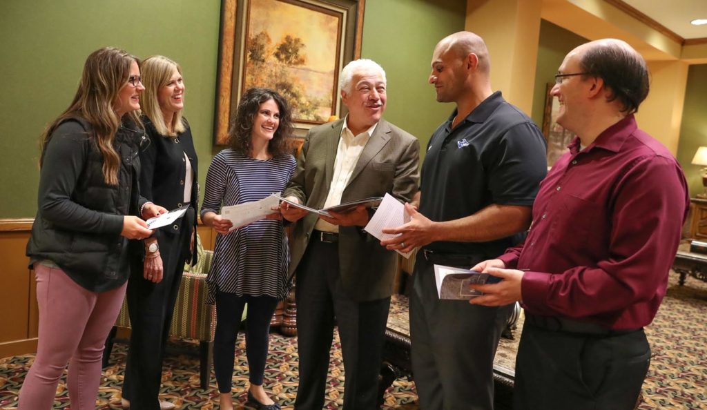 Approximately 1 in 8 Kearney residents has a degree from UNK. Among the many UNK graduates working locally are, from left, Heather Estes, Lori Roach, Maggie Younes-Holz, Paul Younes, Dan Younes and Joshua McIntosh of Younes Hospitality. (Photo by Corbey R. Dorsey, UNK Communications)