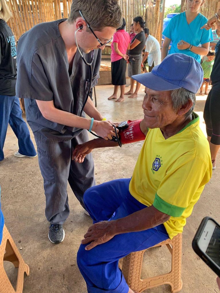 UNK student Bailey Premer checks a patient’s vital signs at a mobile medical clinic in Panama. Twenty-one members of the UNK chapter of Volunteers Around the World traveled to the Central American country last month to work in mobile medical clinics that provided free care and medication to more than 300 patients. (Courtesy photo)