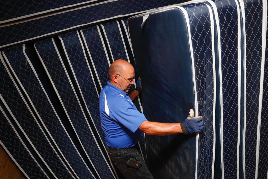 Don Wellensiek organizes retired mattresses from UNK residence halls, which are donated to nonprofits and organizations that serve the community and help people in need. He is retiring after 15 years at UNK. (Photo by Corbey R. Dorsey, UNK Communications)