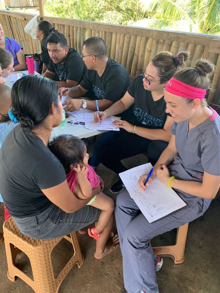 UNK student Kaitlyn Pineda, right, works with patients at a mobile medical clinic during a recent Volunteers Around the World trip to Panama. (Courtesy photo)