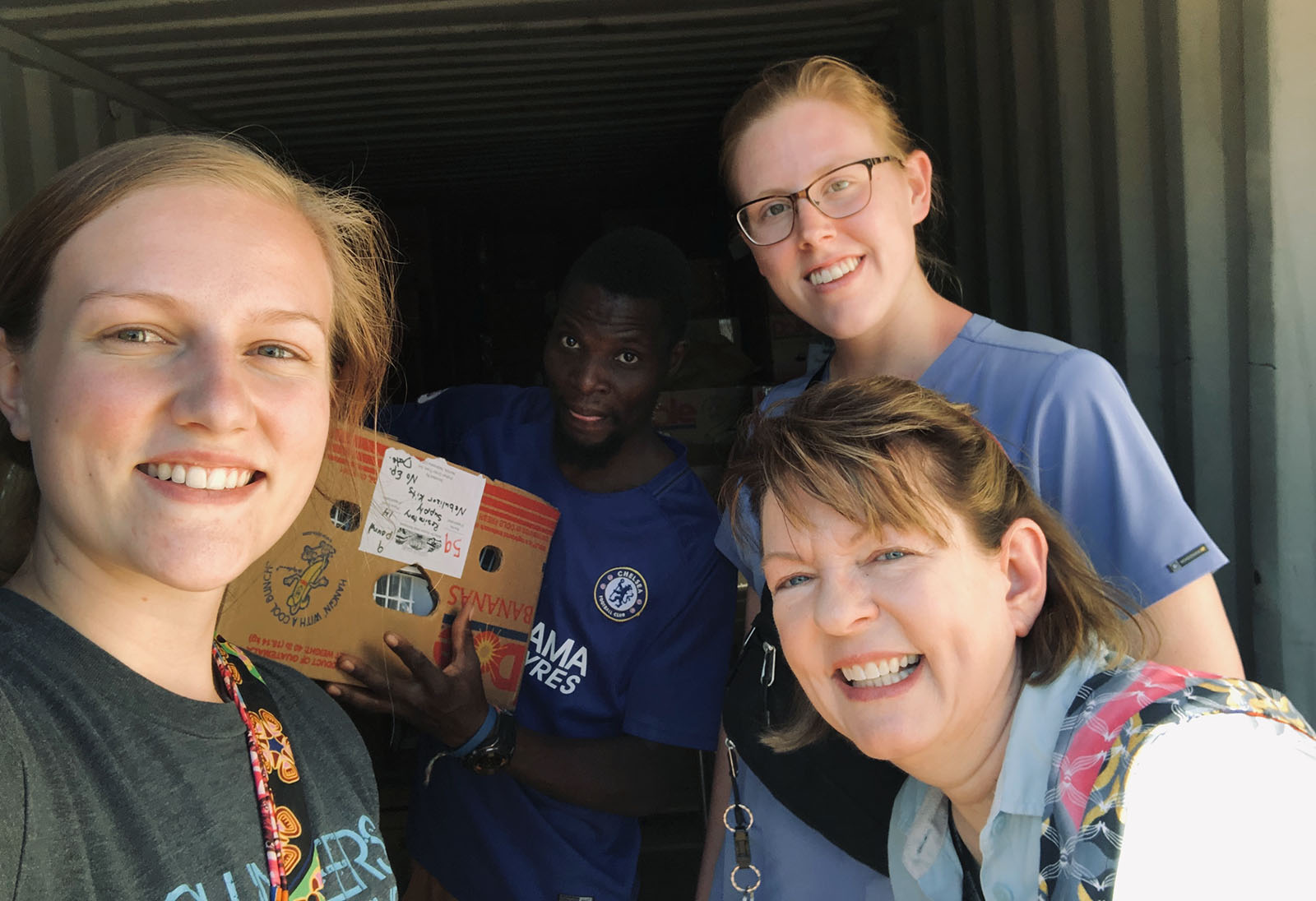 Tessa Copp, Michaela Walker and Michelle Fleig-Palmer pause for a photo while distributing donations during their trip to Zambia. (Courtesy photo)