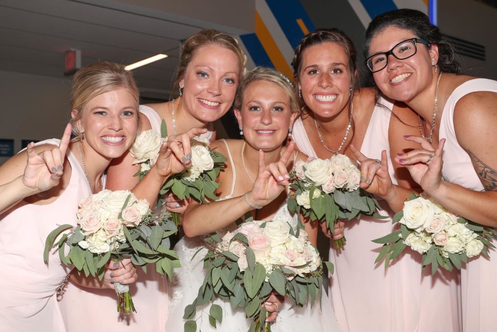 Megan Woeste, center, and her bridesmaids, from left, Bree Adams, Chelsea Leggott, Mackenzie Edgar and Fredde Reed all attended UNK and were members of the Alpha Omicron Pi sorority. They celebrated Woeste’s wedding Saturday during a reception at UNK’s Nebraskan Student Union. (Photo by Corbey R. Dorsey, UNK Communications)