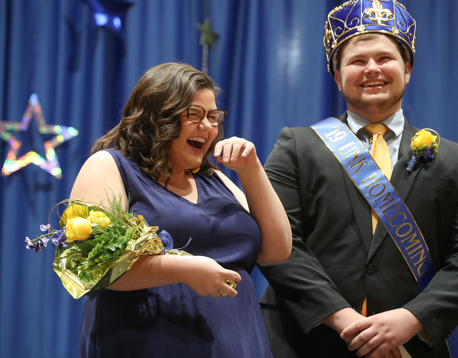 Makenzie Petersen reacts after she was named UNK’s homecoming queen earlier this month. Her best friend, Jacob Roth of Milford, right, was crowned homecoming king. (Photos by Corbey R. Dorsey, UNK Communications)