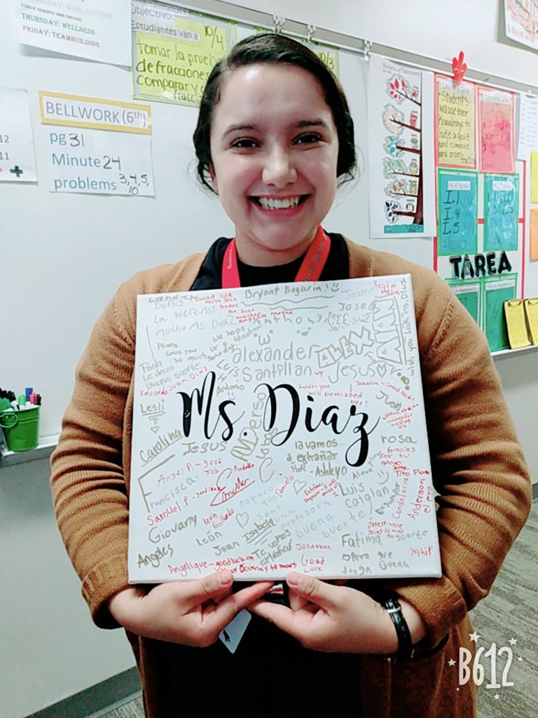 Emely Diaz, a first-generation UNK student, displays a canvas signed by students at Norris Middle School in Omaha. Diaz gained hands-on experience in classrooms in Kearney, Lexington and Omaha before she started student teaching this semester at RM Marrs Magnet Center, which is part of Omaha Public Schools.