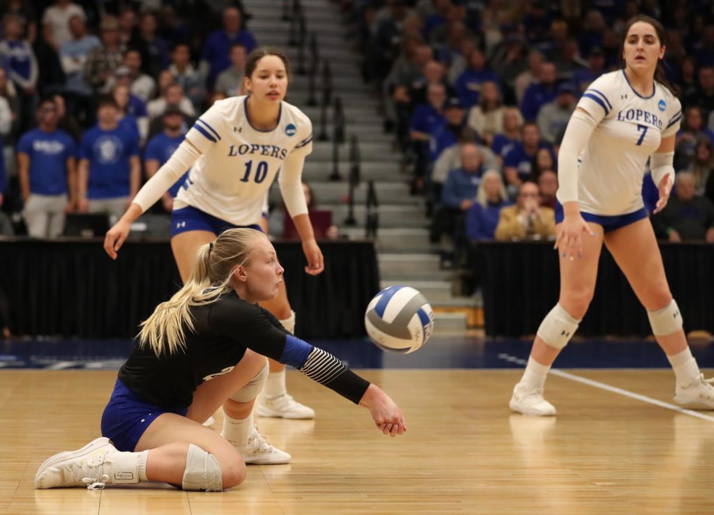 Sophomore libero Lindsay Nottlemann digs a ball as UNK teammates Julianne Jackson (10) and Anna Squiers (7) look on Saturday during the NCAA Division II women’s volleyball championship at the Auraria Event Center in Denver.