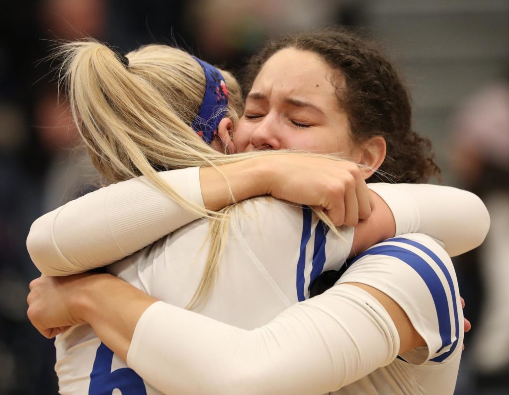 Senior outside hitter Julianne Jackson, right, embraces junior setter Maddie Squiers after UNK’s loss to Cal State San Bernardino in Saturday’s NCAA Division II national championship match at the Auraria Event Center in Denver.