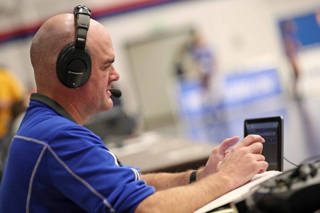 KRVN play-by-play broadcaster Jayson Jorgensen calls Saturday’s NCAA Division II title match in Denver. “I appreciate this because I realize these moments, national championship settings like this, don’t come around often,” Jorgensen said. (Photo by Corbey R. Dorsey, UNK Communications)