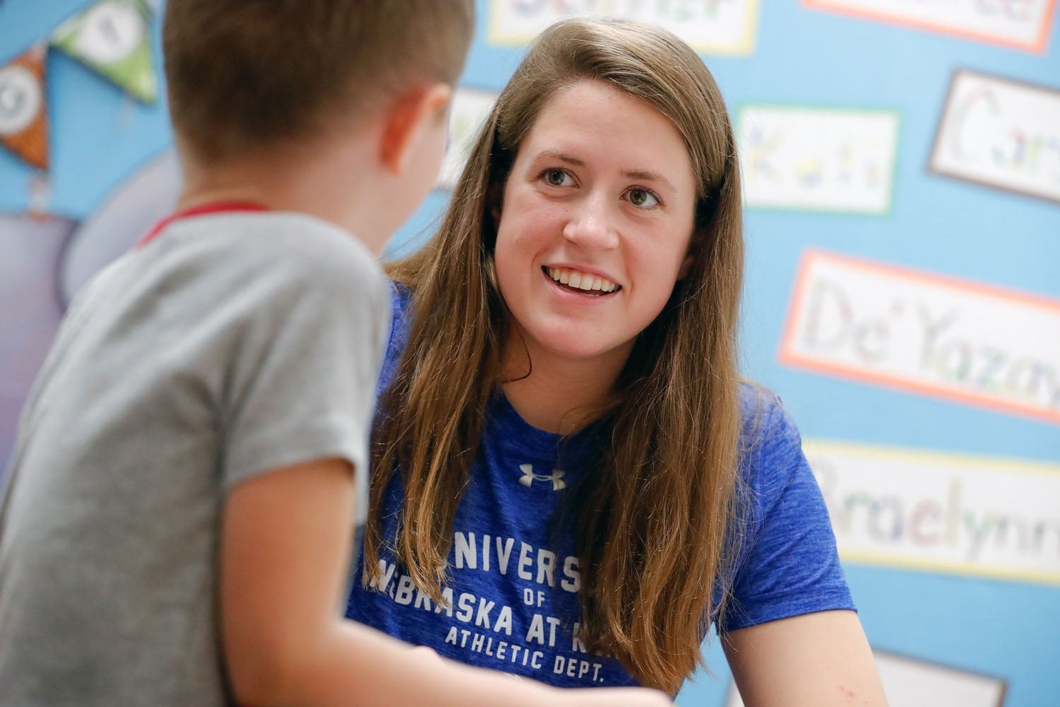 UNK swimmer Mikara Feit, a 7-12 special education major, chats with a kindergartner at Kenwood Elementary School in Kearney as part of the Loper AthLEADS program, which encourages UNK student-athletes and coaches to make a difference on campus and in the community.