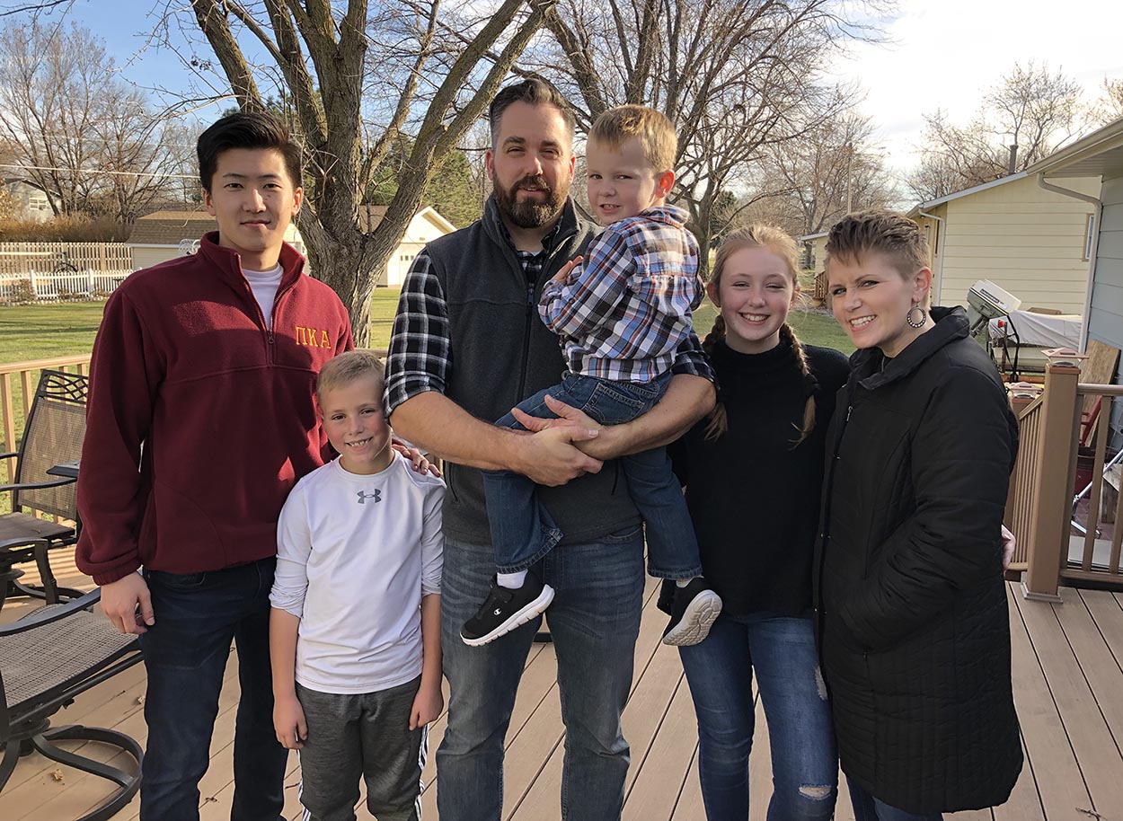 UNK student Ryo Kawamoto, left, is pictured with the Nebesniak family last Thanksgiving. Members of the Nebesniak family are, from left, 10-year-old Kael, Pat, 5-year-old Xander, 13-year-old Denelle and Amy. (Courtesy photos)