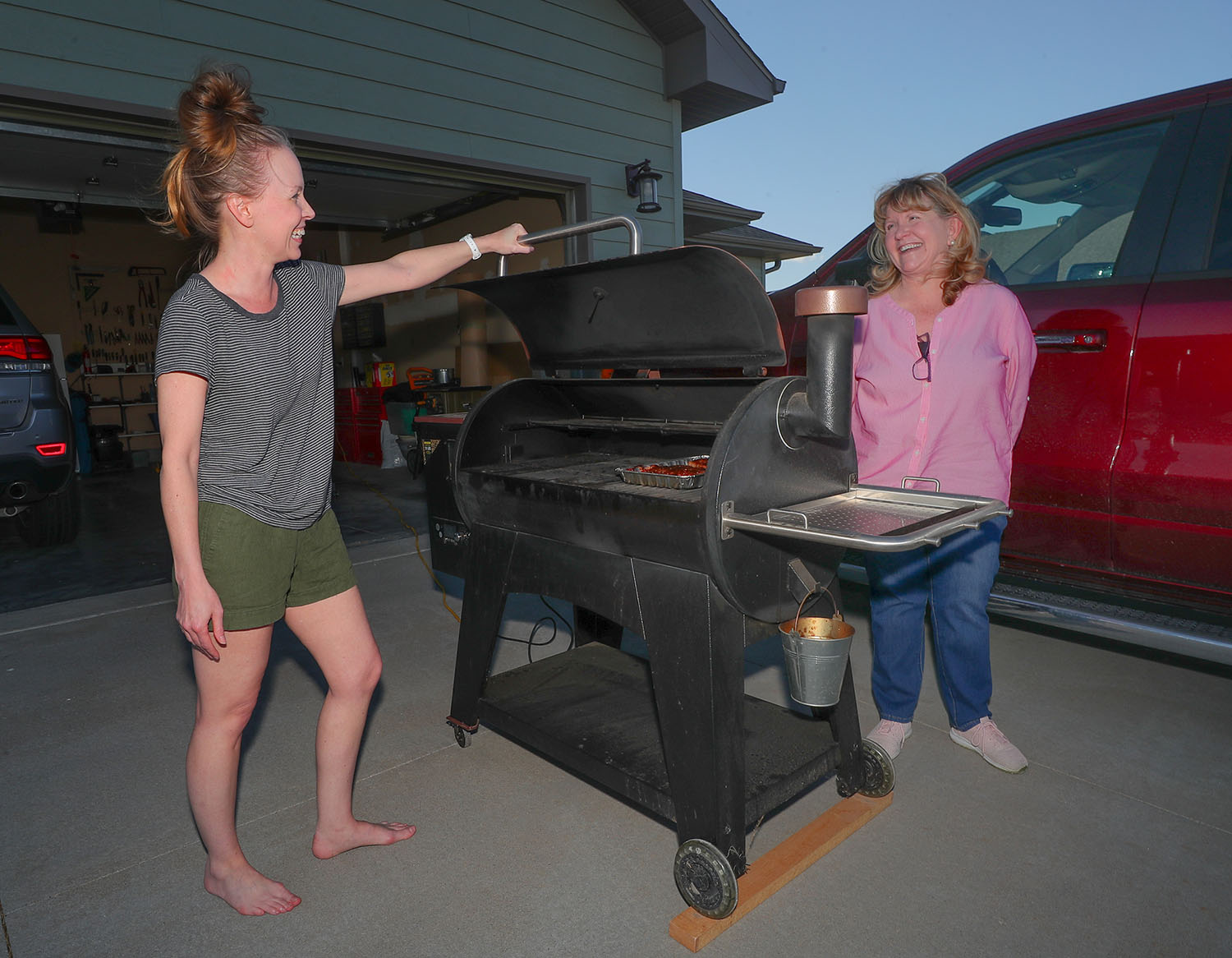 UNK family studies professor Tami Moore, right, chats with neighbor Jolene Jahn on Tuesday evening. Moore and UNK exercise science professor Greg Brown teamed up to start neighborhood celebrations in Kearney that allow people to interact while following social distancing guidelines.