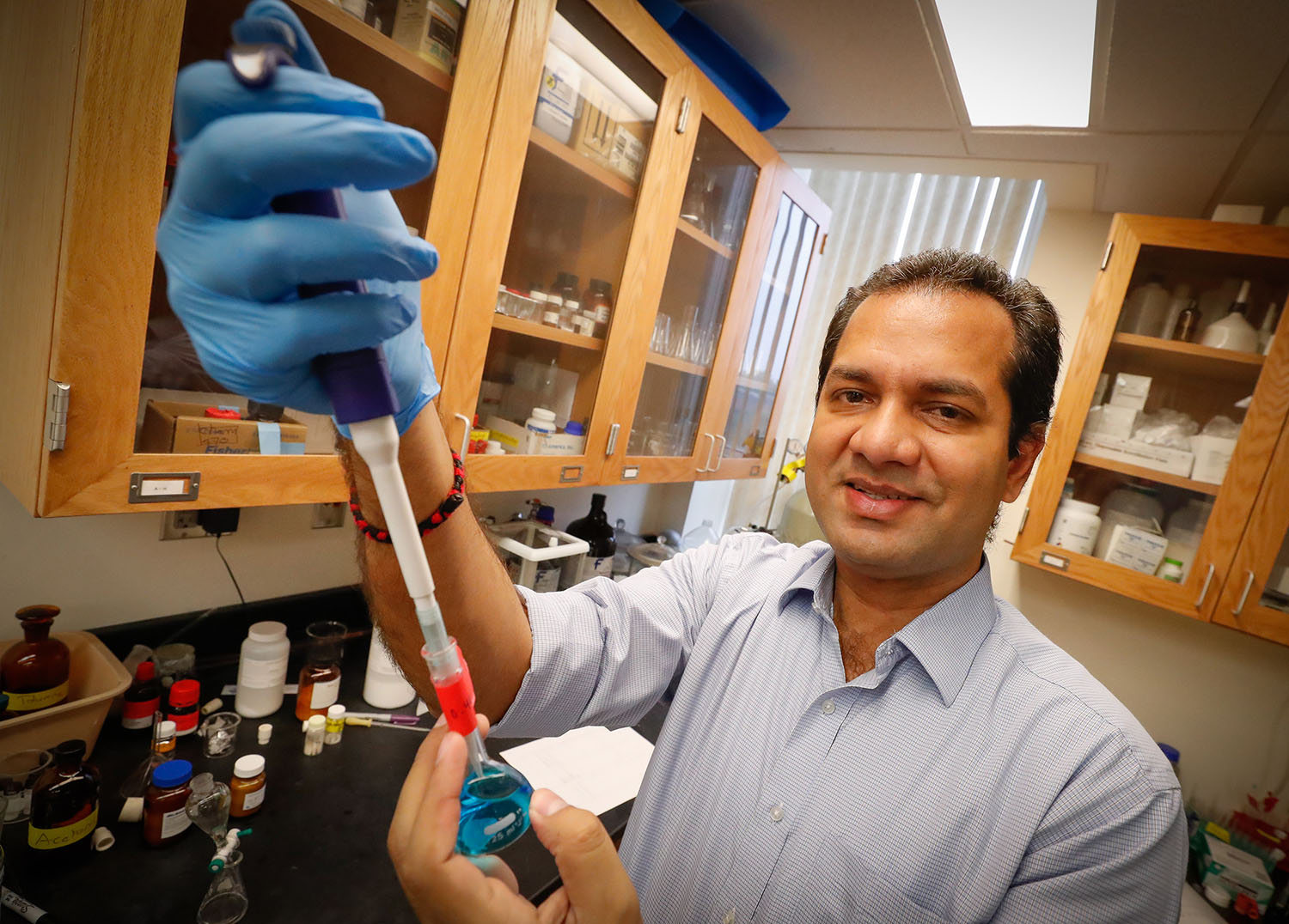 UNK associate chemistry professor Mahesh Pattabiraman is researching photoactive dyes that generate disinfecting molecules when they’re exposed to light. The goal is to develop an effective and safe disinfectant for prosthetic limbs. (Photo by Corbey R. Dorsey, UNK Communications)