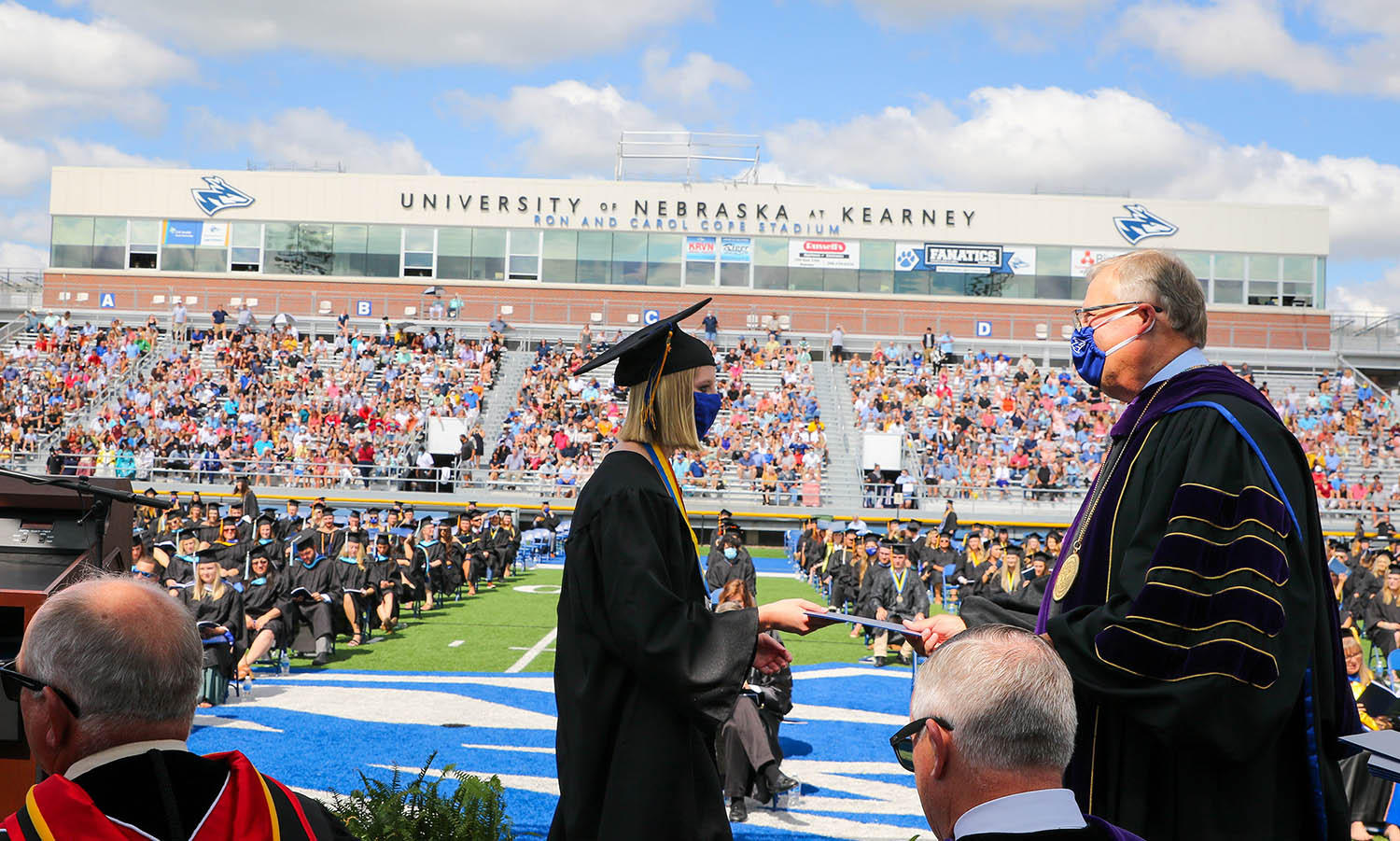 UNK graduate Haley Pierce of West Point has her degree conferred by Chancellor Doug Kristensen during Friday’s commencement ceremony at Cope Stadium.