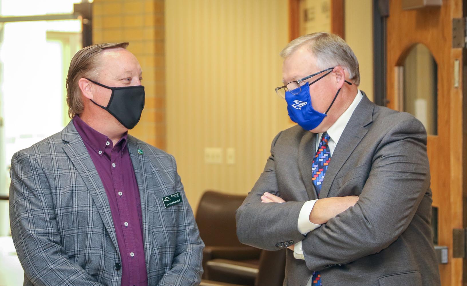 Central Community College President Matt Gotschall, left, and UNK Chancellor Doug Kristensen chat during Friday’s ribbon-cutting celebrating UNK’s new partnership with College Park at Grand Island.