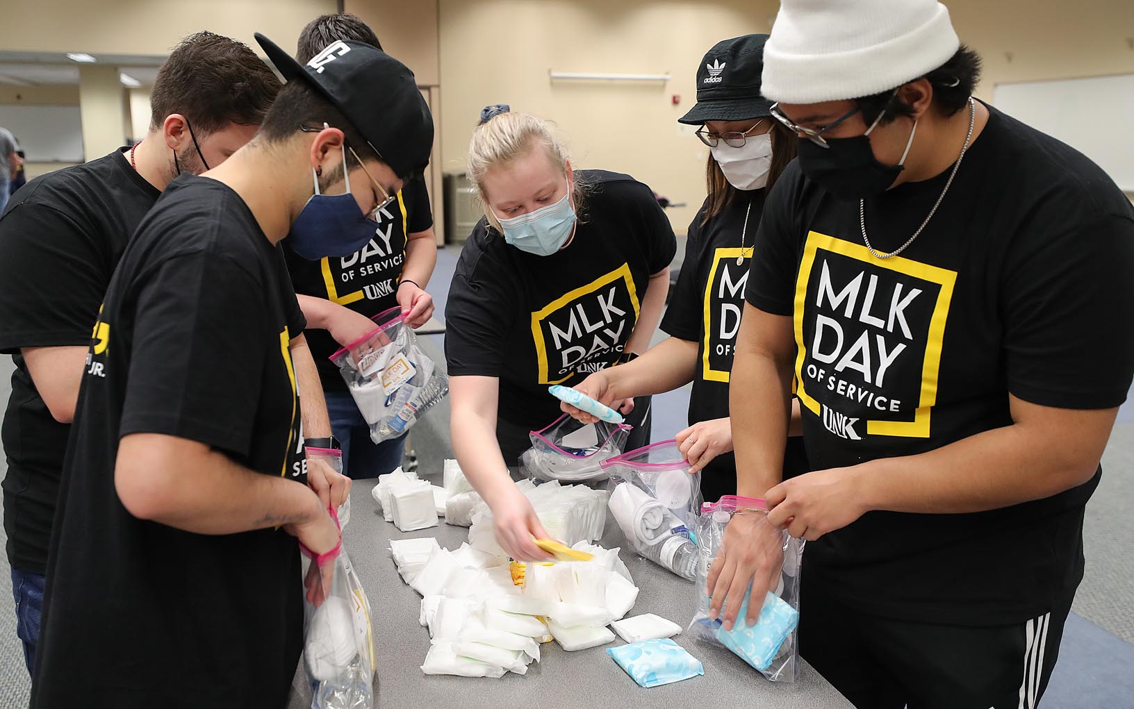 Clockwise from left, UNK students Dado Castillo, Adrian Almeida, Isaac McDowell, Kiersten Lubke, Ana Flores and Daniel Ocampo fill care packages Friday during the MLK Day of Service. The packages will be delivered to Crossroads Mission Avenue and Kearney Jubilee Center. (Photos by Erika Pritchard, UNK Communications)