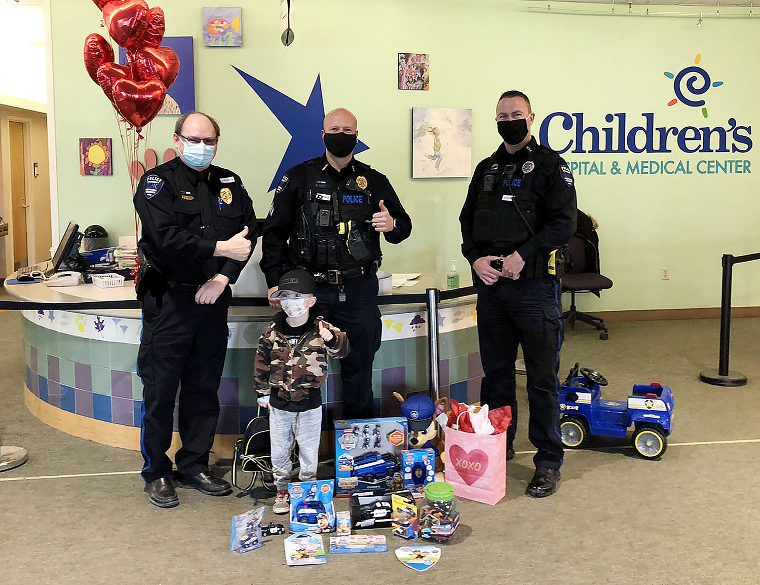 From left, UNK Police Chief Jim Davis, Sgt. Ricci Fast and Officer Scott Seals pose for a photo with 5-year-old Jaiden Kissinger during their visit to Children’s Hospital and Medical Center in Omaha. (Courtesy photo)