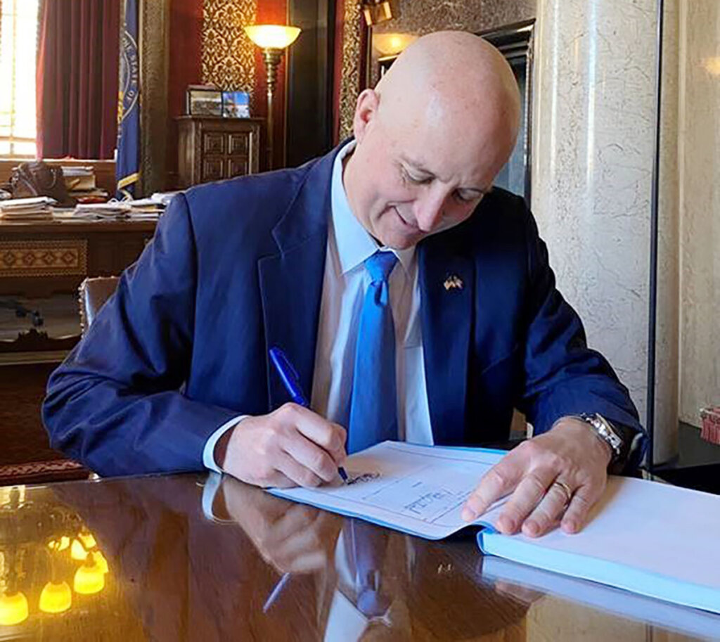 Gov. Pete Ricketts signs the state budget into law Monday.