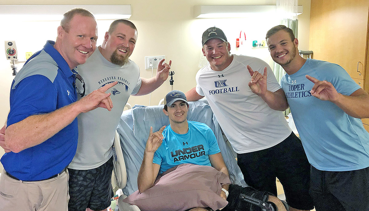 From left, UNK head football coach Josh Lynn and former players David Squiers, Preston Hall, Tye Spies and Carson Walters are pictured at Madonna Rehabilitation Hospital in Lincoln following Hall’s accident in summer 2018.